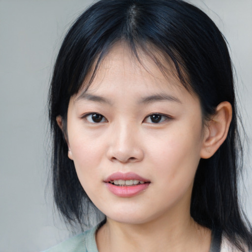 Joyful asian young-adult female with medium  black hair and brown eyes