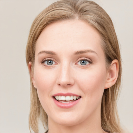 Joyful white young-adult female with long  brown hair and blue eyes