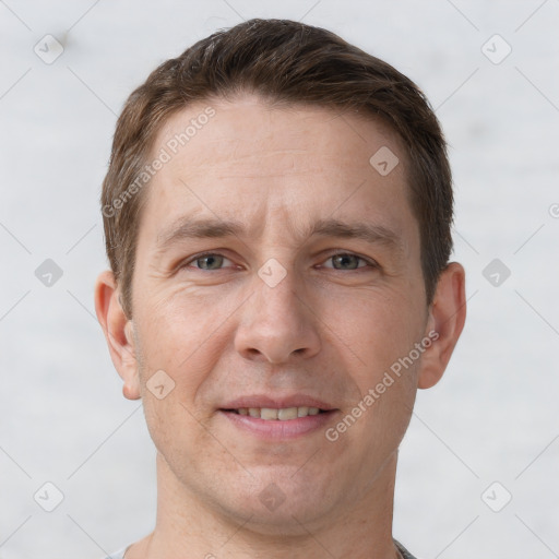 Joyful white adult male with short  brown hair and grey eyes