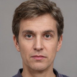 Joyful white adult male with short  brown hair and grey eyes