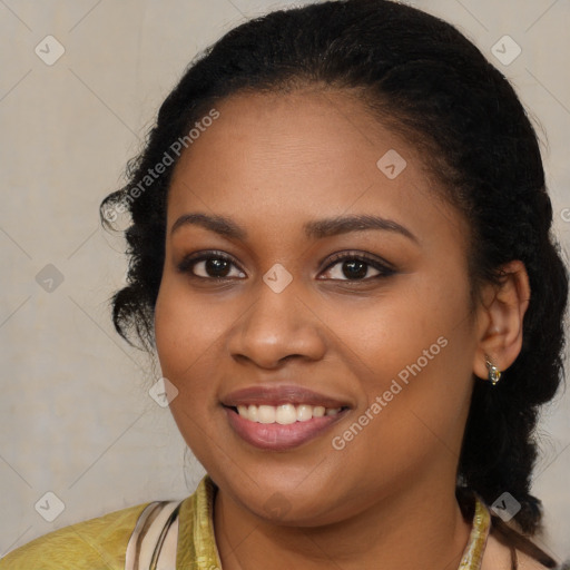 Joyful black young-adult female with long  brown hair and brown eyes