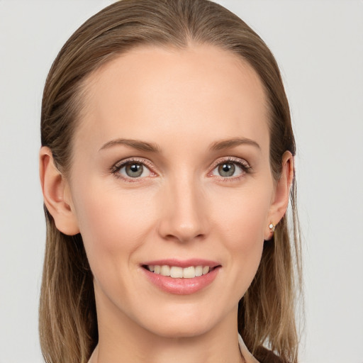 Joyful white young-adult female with long  brown hair and grey eyes