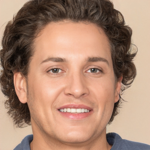 Joyful white adult male with medium  brown hair and brown eyes