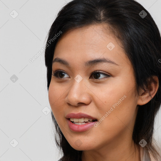 Joyful latino young-adult female with long  brown hair and brown eyes