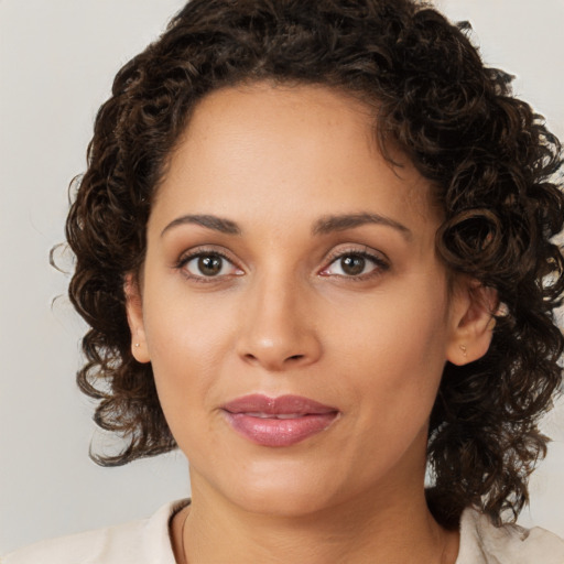 Joyful white young-adult female with medium  brown hair and brown eyes