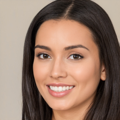 Joyful latino young-adult female with long  black hair and brown eyes