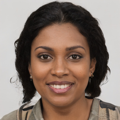 Joyful black young-adult female with medium  brown hair and brown eyes