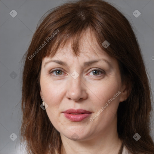 Joyful white adult female with medium  brown hair and grey eyes