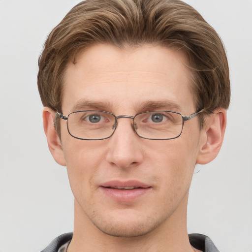 Joyful white adult male with short  brown hair and grey eyes