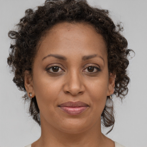 Joyful black adult female with medium  brown hair and brown eyes
