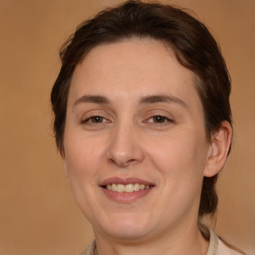 Joyful white adult female with medium  brown hair and brown eyes