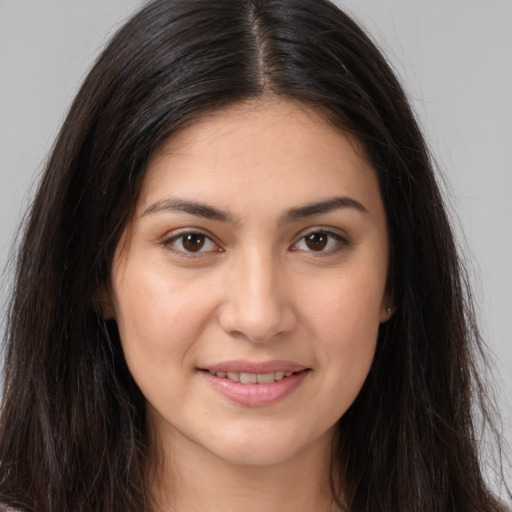 Joyful white young-adult female with long  brown hair and brown eyes