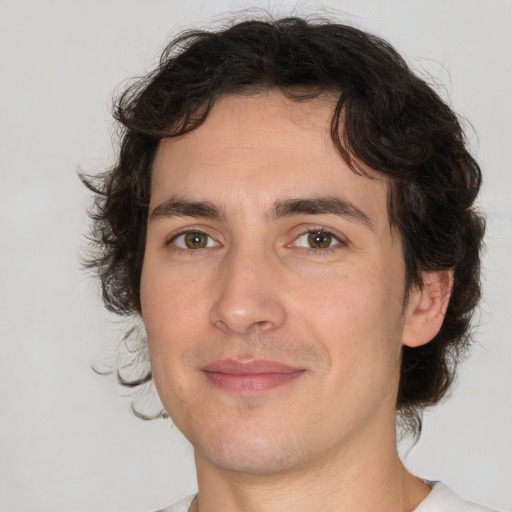 Joyful white young-adult male with medium  brown hair and brown eyes