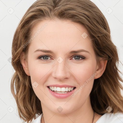 Joyful white young-adult female with medium  brown hair and blue eyes