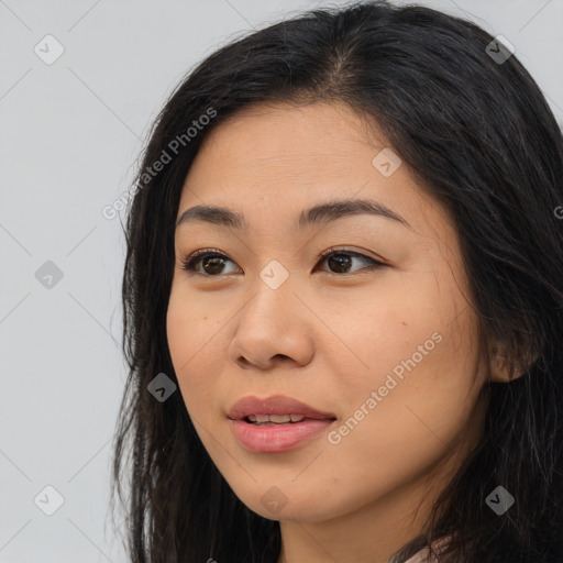 Joyful latino young-adult female with long  brown hair and brown eyes