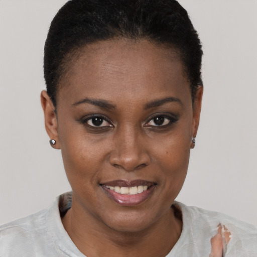 Joyful black young-adult female with short  brown hair and brown eyes