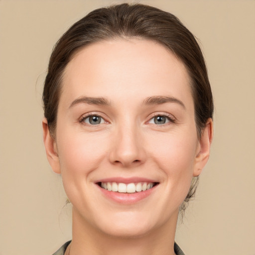 Joyful white young-adult female with medium  brown hair and grey eyes