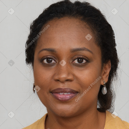 Joyful black adult female with long  brown hair and brown eyes