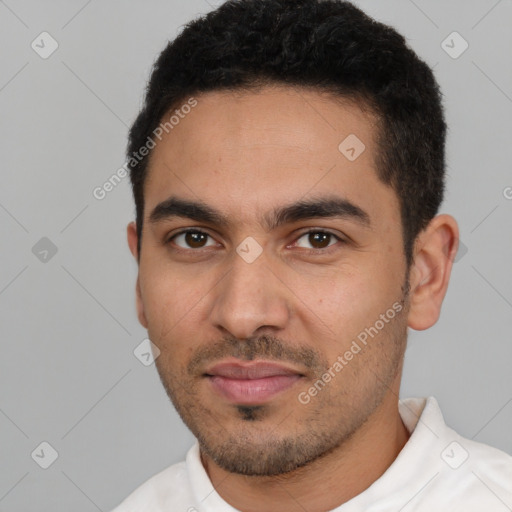 Joyful latino young-adult male with short  black hair and brown eyes