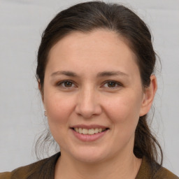 Joyful white young-adult female with medium  brown hair and brown eyes