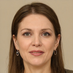 Joyful white adult female with long  brown hair and grey eyes