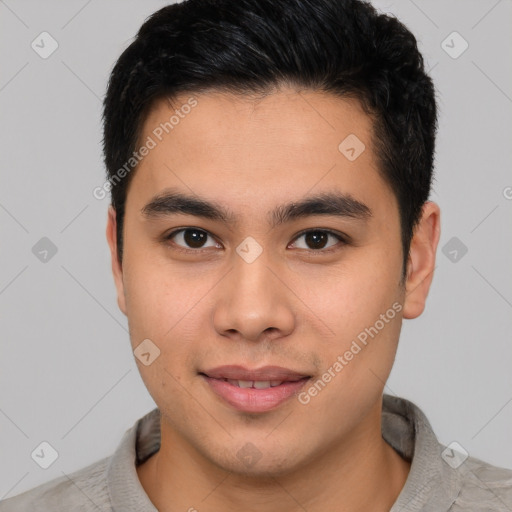 Joyful latino young-adult male with short  brown hair and brown eyes