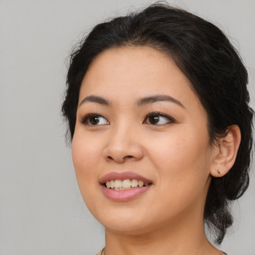 Joyful asian young-adult female with long  brown hair and brown eyes