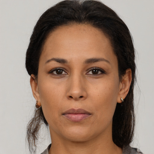 Neutral latino young-adult female with medium  brown hair and brown eyes