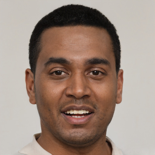 Joyful black young-adult male with short  black hair and brown eyes