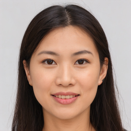 Joyful asian young-adult female with long  brown hair and brown eyes