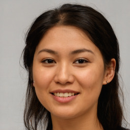 Joyful asian young-adult female with long  brown hair and brown eyes