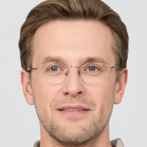 Joyful white adult male with short  brown hair and grey eyes