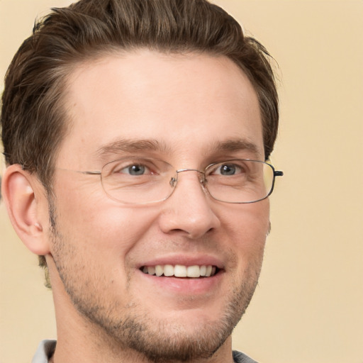 Joyful white adult male with short  brown hair and grey eyes