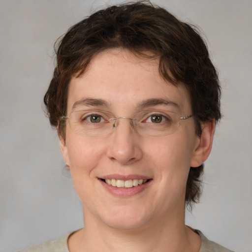 Joyful white adult female with medium  brown hair and green eyes