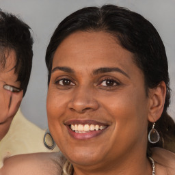 Joyful black adult female with medium  brown hair and brown eyes