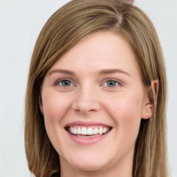 Joyful white young-adult female with long  brown hair and blue eyes