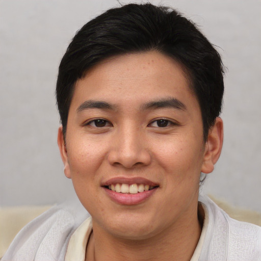 Joyful asian young-adult female with short  black hair and brown eyes
