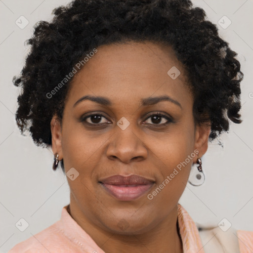 Joyful black adult female with short  brown hair and brown eyes