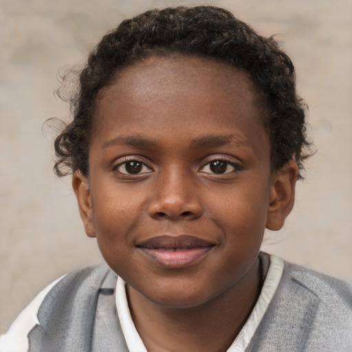Joyful black child female with short  brown hair and brown eyes