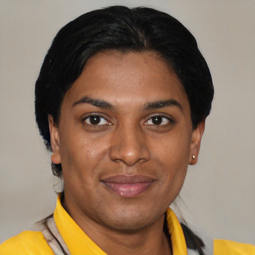 Joyful latino young-adult female with short  black hair and brown eyes