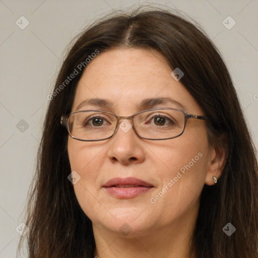 Joyful white adult female with long  brown hair and brown eyes