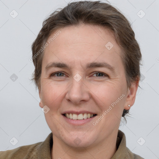 Joyful white adult female with short  brown hair and grey eyes