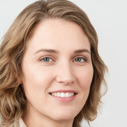 Joyful white young-adult female with long  brown hair and green eyes