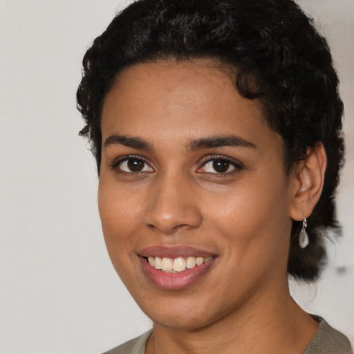 Joyful latino young-adult female with short  black hair and brown eyes