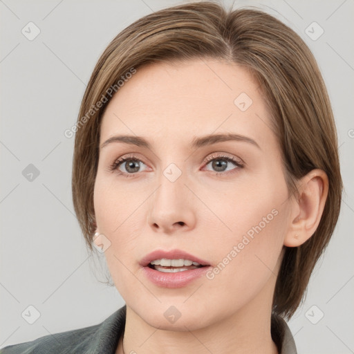 Joyful white young-adult female with medium  brown hair and grey eyes