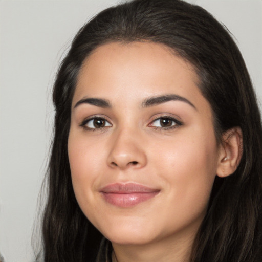 Joyful latino young-adult female with long  black hair and brown eyes