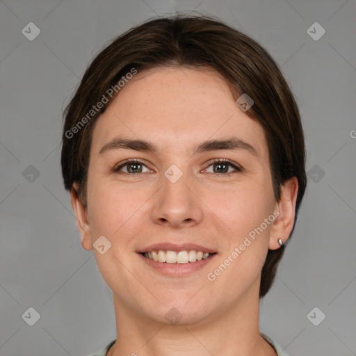 Joyful white young-adult female with short  brown hair and grey eyes