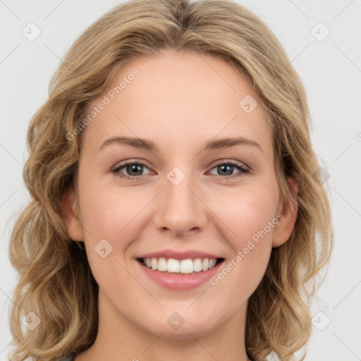 Joyful white young-adult female with long  brown hair and green eyes