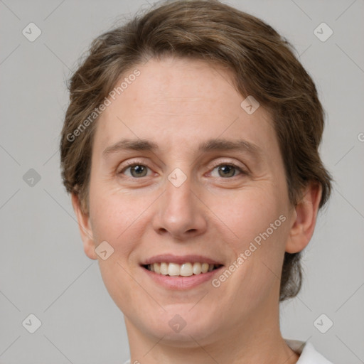 Joyful white young-adult female with short  brown hair and grey eyes