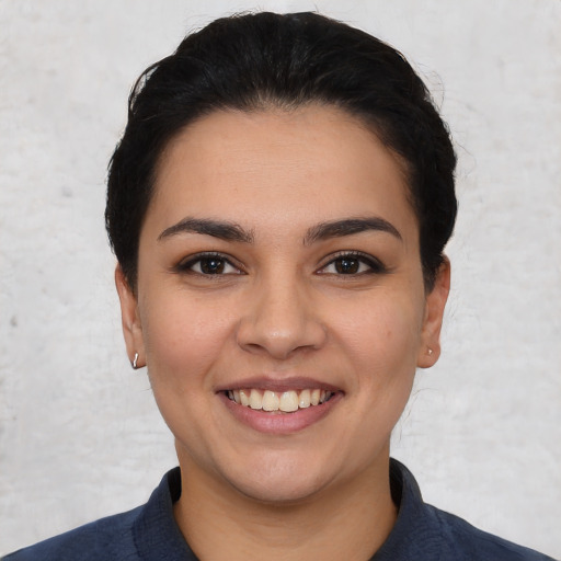 Joyful white young-adult female with short  black hair and brown eyes